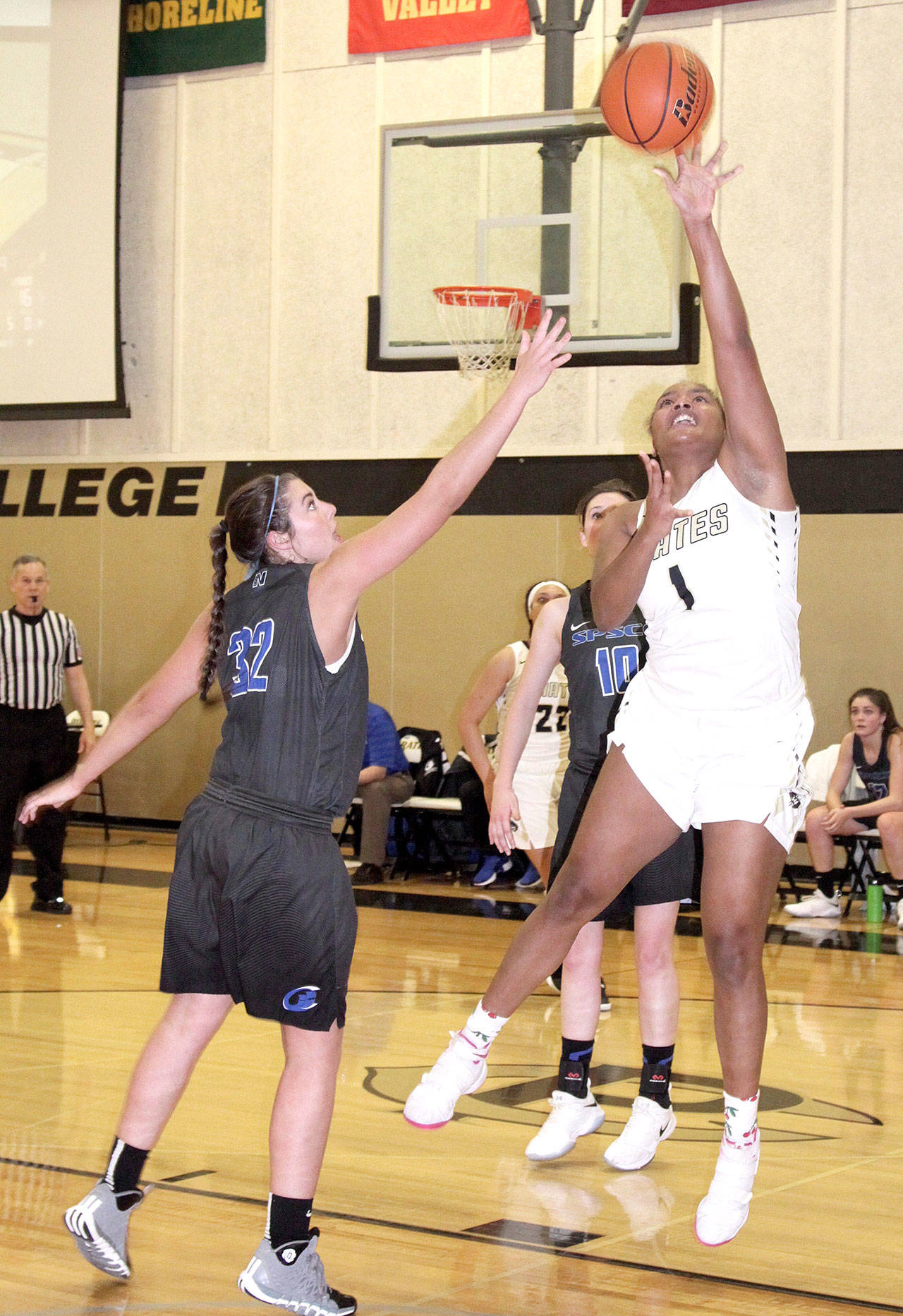 Peninsula’s Jamellia Clark goes up for a shot over the defense of Darion Brown of the South Puget Sound Clippers. (Dave Logan/for Peninsula Daily News)