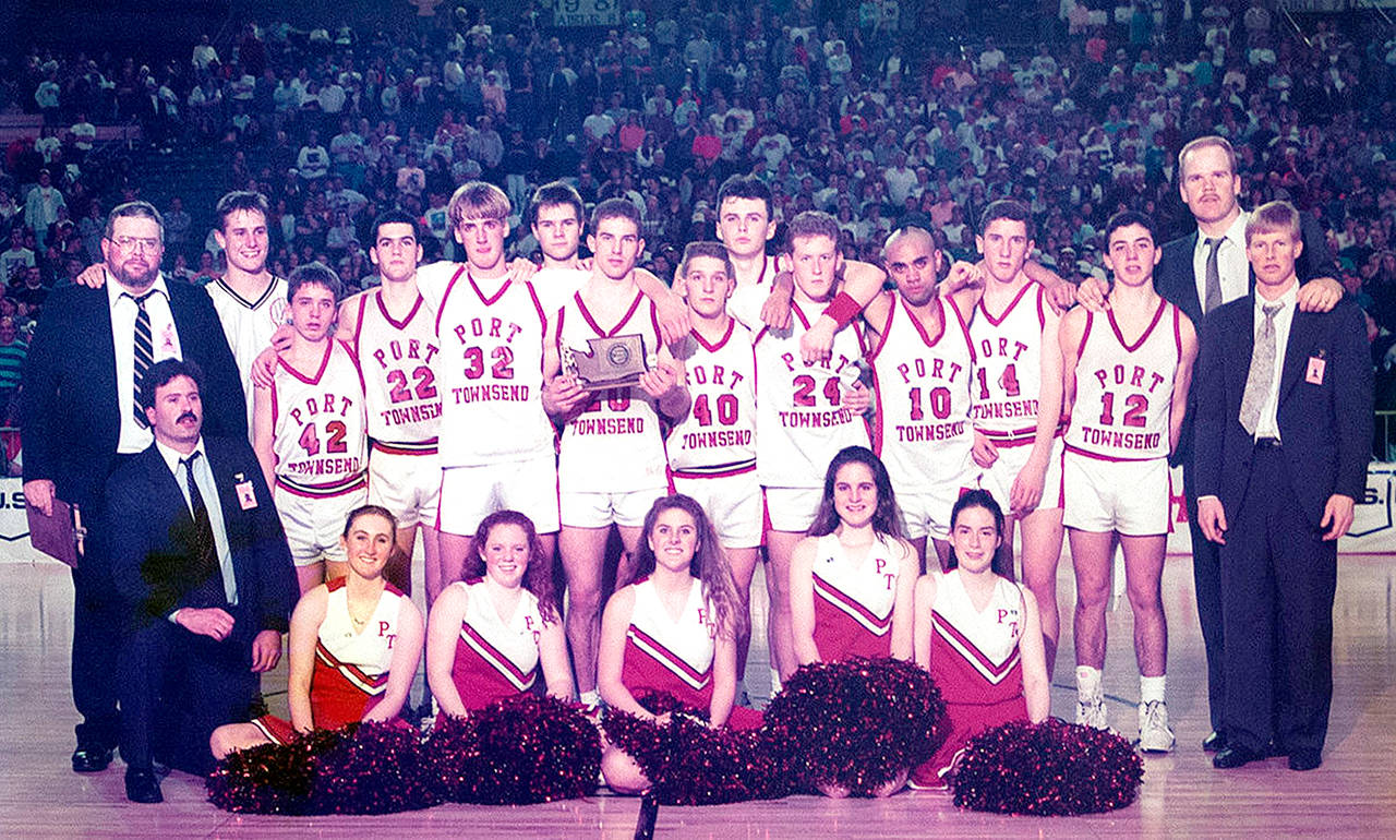 The 1992-93 Port Townsend boys basketball team finished second at the Class A State Basketball Tournament. Coaches and players, from left, back row, coach Tim Black, Calan Taylor, Tanner Logue, Dan Rough, Kevin Maier, Dekker Dirksen, Andy D’Agostino (with trophy), Kevin Reid, Luke Eaton, Aaron Speck, Emanuel Abbott, Joe Atkinson, Rich D’Agostino, coach John Stroeder, head coach Ryan Robertson; (kneeling, from left) coach Mike Kelly, and cheerleaders Carissa Parker, Ali Armstrong, Kim Erickson, Kim Schubert and Bethany Schultz. Photo: Kris Logue
