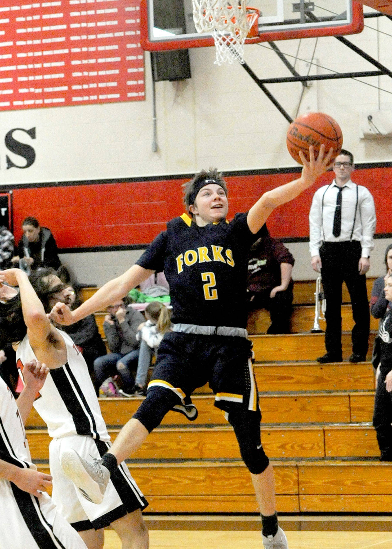 Forks’ Joseph Reaume scores around the defense of Tenino’s Tony Canepa during the Spartans’ 62-28 victory Tuesday. Lonnie Archibald/for Peninsula Daily News