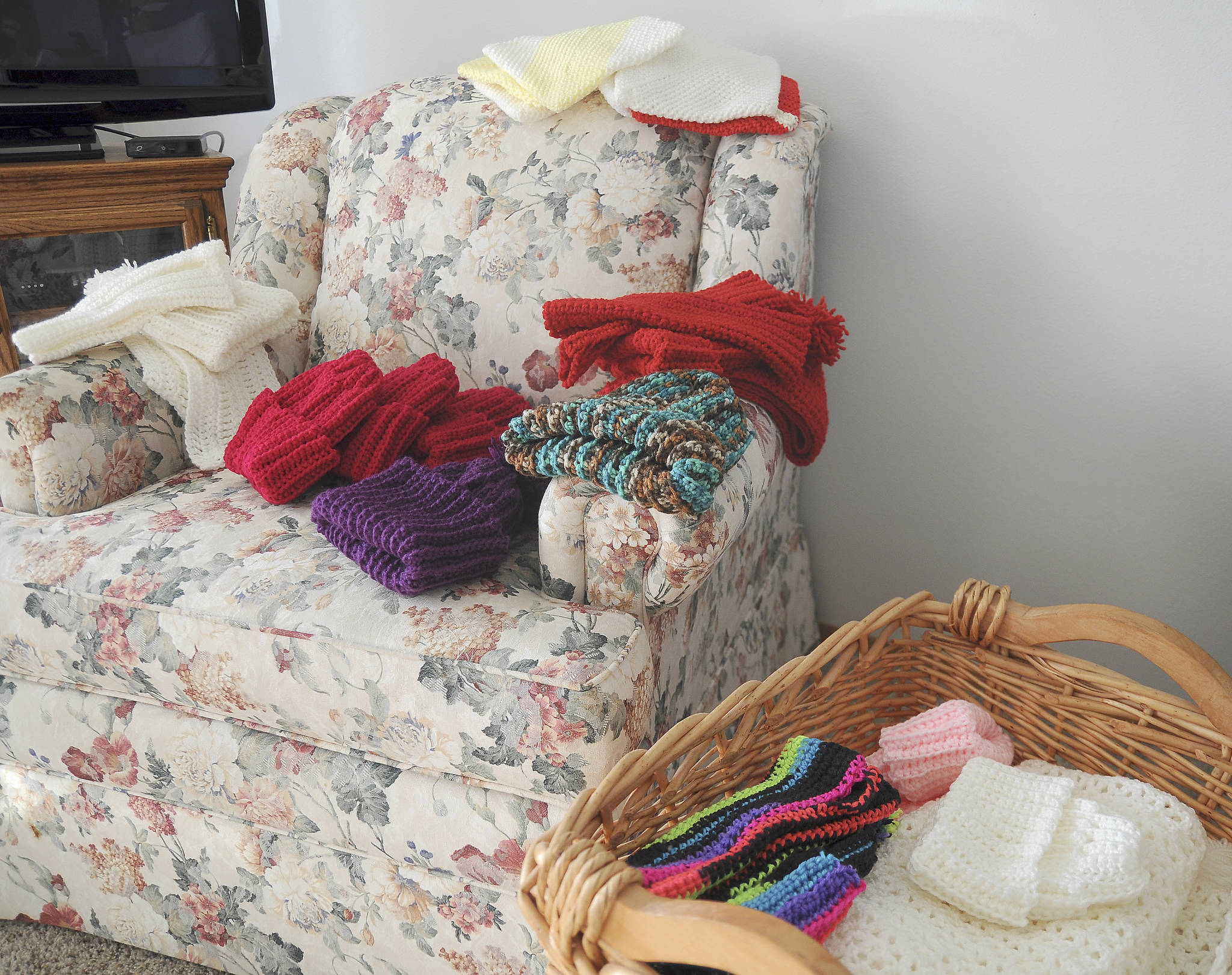 With decades of donating hats and scarves, Phyllis Peashka estimates she’s completed at least 10,000 pieces over the years. (Michael Dashiell/Olympic Peninsula News Group)