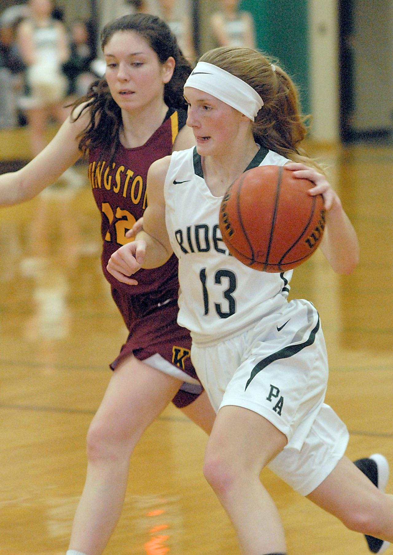 Keith Thorpe/Peninsula Daily News Port Angelesâ Millie Long sweeps past Kingstonâs Lily Beaulieu in the second quarter on Friday night at Port Angeles High School.