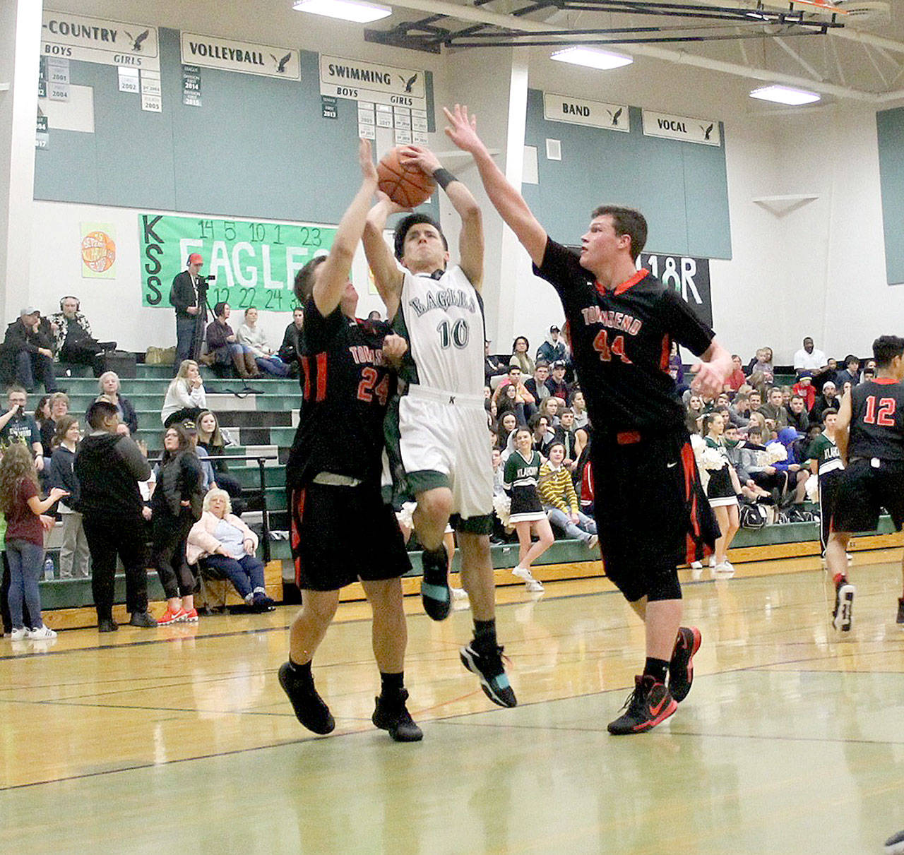 Port Townsend’s Payton Lake, left and Jackson Foster, right, defend against Klahowya’s Tom Coots (10) during the Redhawks’ 61-54 win Saturday at Klahowya High School. The victory handed Port Townsend the Olympic League 1A Division championship. (Jacob Moore/North Kitsap Herald)
