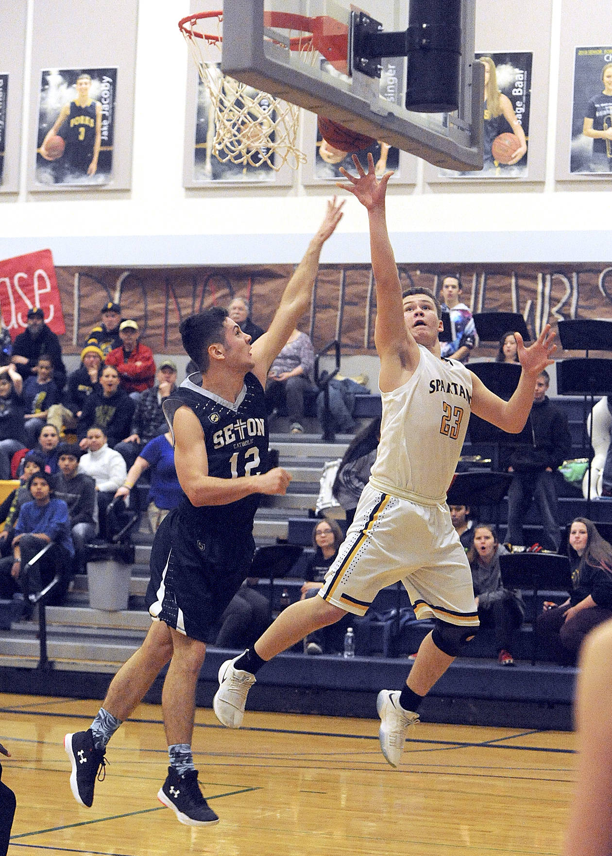 <strong>Lonnie Archibald</strong>/for Peninsula Daily News Forks’ Braton Armas, right, scores around Seton Catholic’s Hayden Miller during the Spartans’ Southwest District 4 playoff game in Forks on Friday.