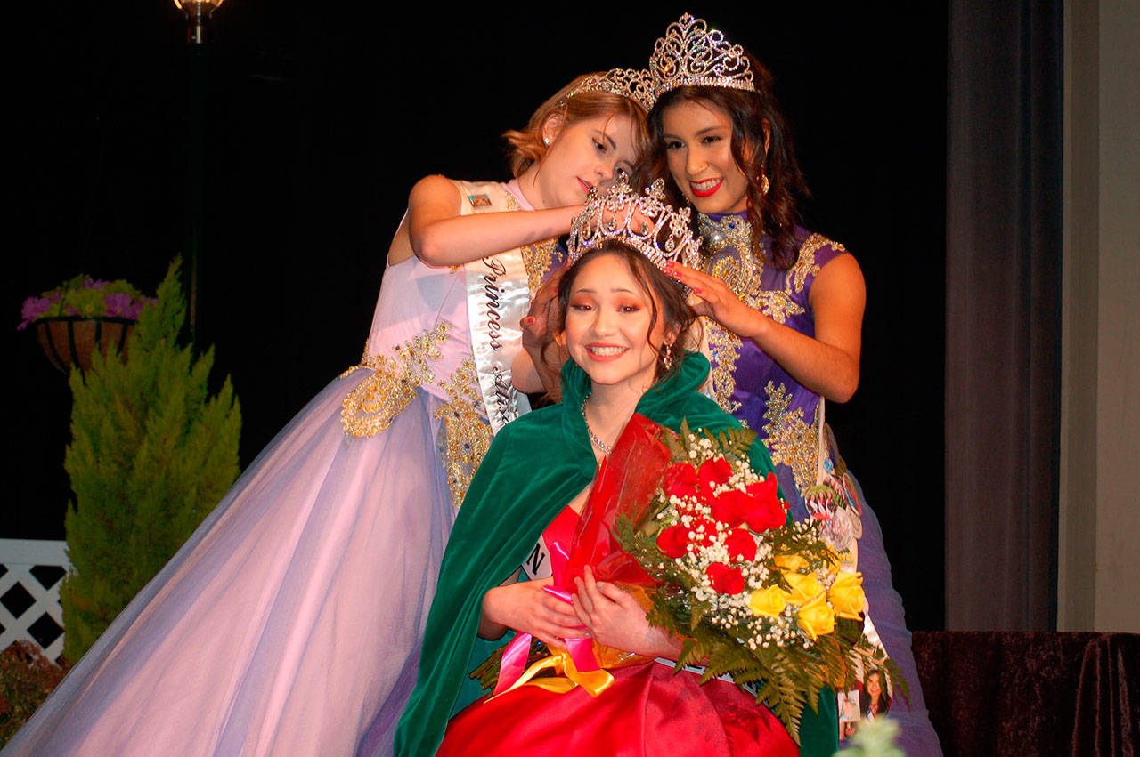 The 2018 Irrigation Festival Royalty Court was crowned Saturday in a packed Sequim High School Auditorium. The 2017 princess, Alison Cobb, and Queen Karla Najera set the crown on the new queen, Erin Gordon, center. (Erin Hawkins/Olympic Peninsula News Group)