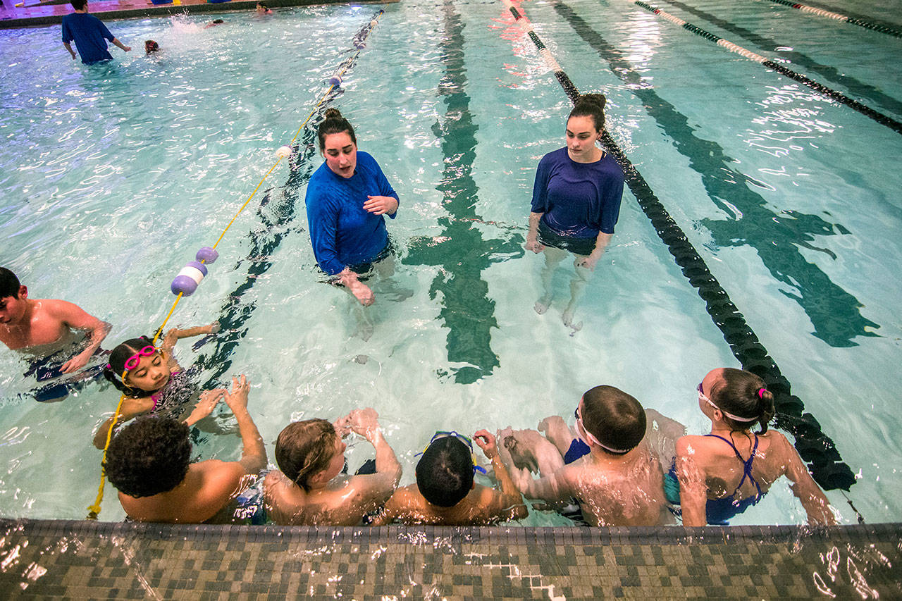Sarah Tiemersma, left, and her sister, Brianna Tiemersma, lead swimming lessons at William Shore Memorial Pool in Port Angeles. The pool is poised to receive $1.5 million from the state to help finance the upcoming pool expansion. (Jesse Major/Peninsula Daily News)