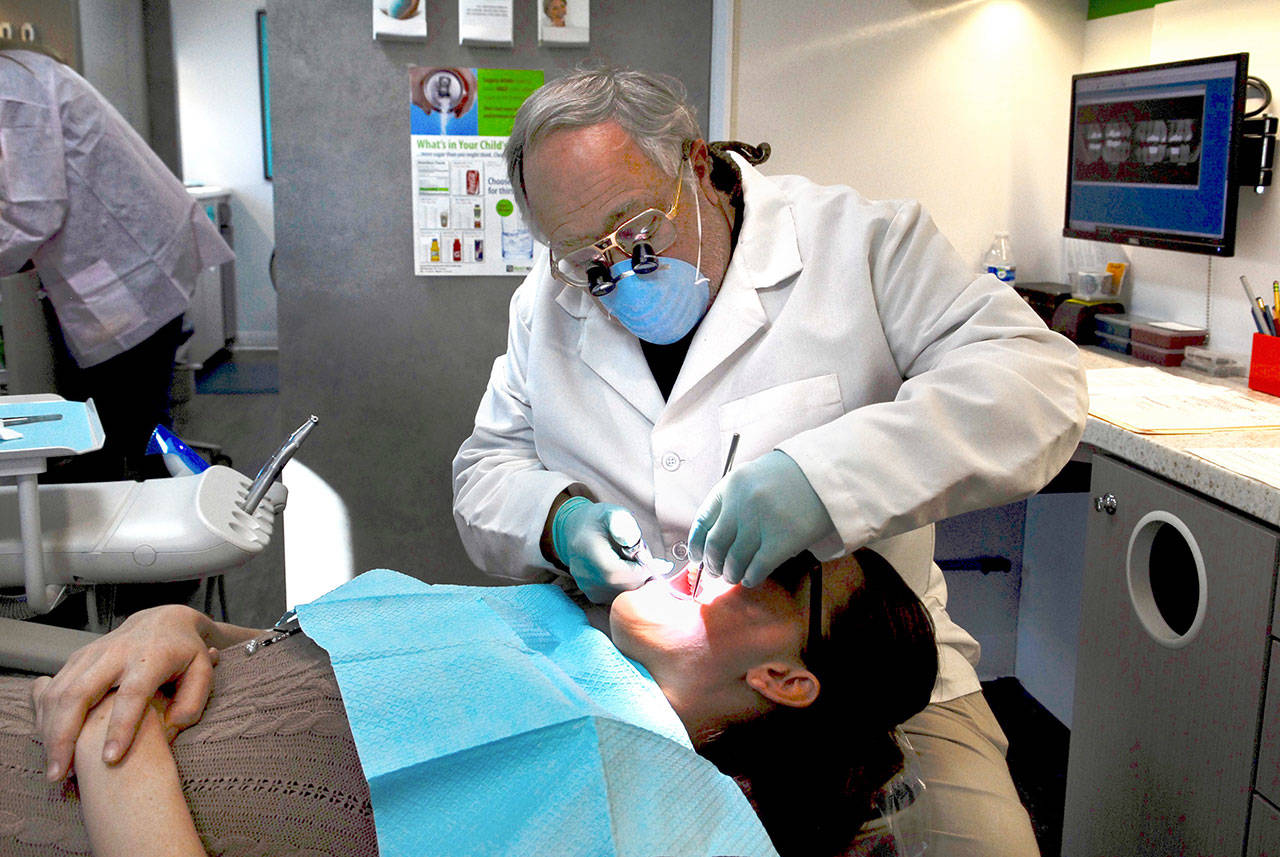 New mom Jessica Turner of Chimacum is taking care of her oral health at the SmileMobile, a dentist-on-wheels program that visited Port Townsend this week. In addition to children, SmileMobile dentist Dr. Paul Phillips believes that pregnant women and new mothers benefit greatly from regular dental checkups. (Jeannie McMacken/Peninsula Daily News)