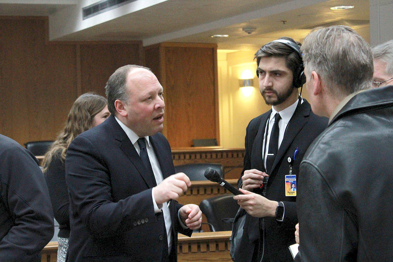 Sen. David Frockt, D-Seattle, speaks with reporters after a hearing on his bill that would enhance background checks for assault weapons, raise the age to purchase an assault weapon and implement school safety procedures. (Taylor McAvoy/WNPA Olympia News Bureau)
