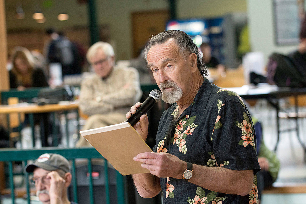 Dan Andrews tells those who attended the forum on school gun violence at Peninsula College on Wednesday that the country has much greater problems than gun control. (Jesse Major/Peninsula Daily News)
