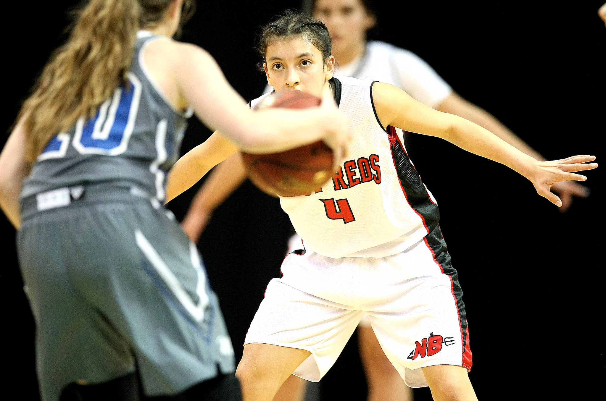 David Willoughby/for Peninsula Daily News                                Neah Bay’s Laila Greene (4) eyes Mount Vernon Christian’s Josie Droog during the Red Devils’ 53-34 Class 1B state quarterfinal win over the Hurricanes at Spokane Arena on Thursday.