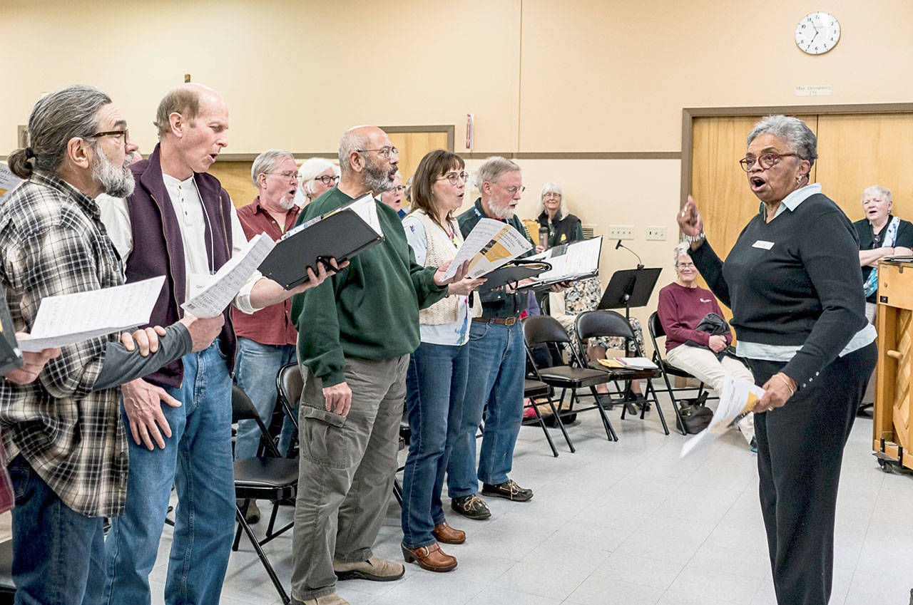 Guest director and gospel specialist Phyllis Byrdwell from the University of Washington rehearses a song with the tenors and basses of the chorus. (Sue Reid)