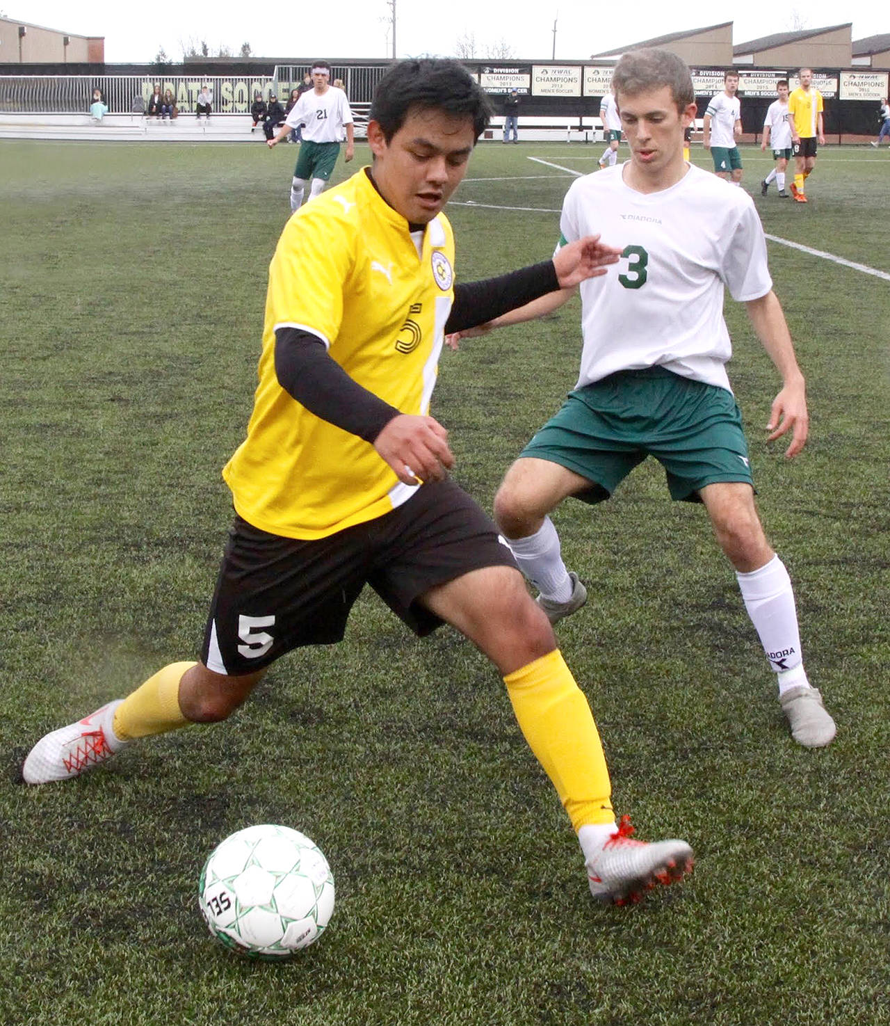 Sequim’s Rudy Franco, left, protects at the ball from Port Angeles’ Andrew St. George during a nonleague friendly match between the two rivals Saturday at Peninsula College. Dave Logan/for Peninsula Daily News