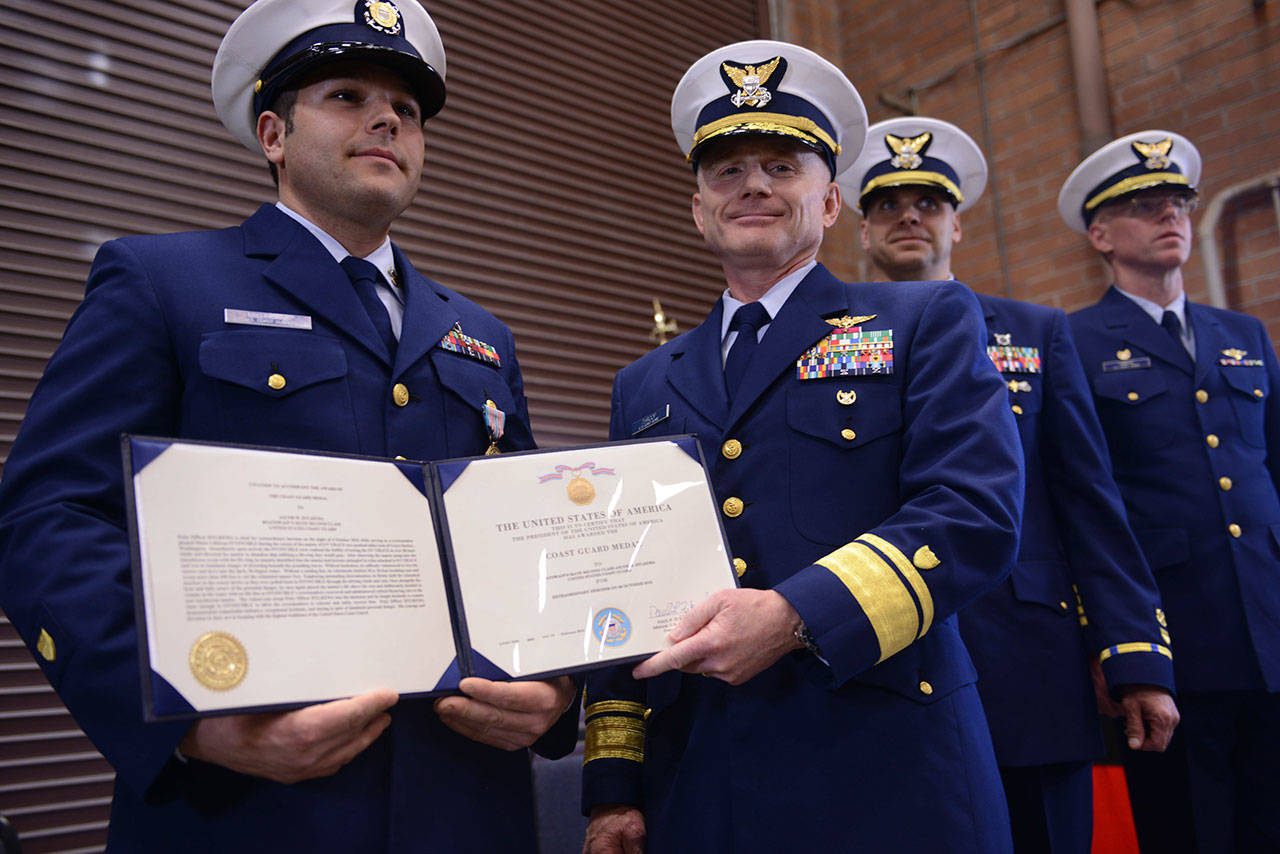 Rear Adm. David Throop, Coast Guard 13th District commander, presents the Coast Guard Medal to Petty Officer First Class Jacob Hylkema, a boatswain’s mate at Coast Guard Station Grays Harbor, during a ceremony held at the station’s base in Westport. (Petty Officer First Class Levi Read)