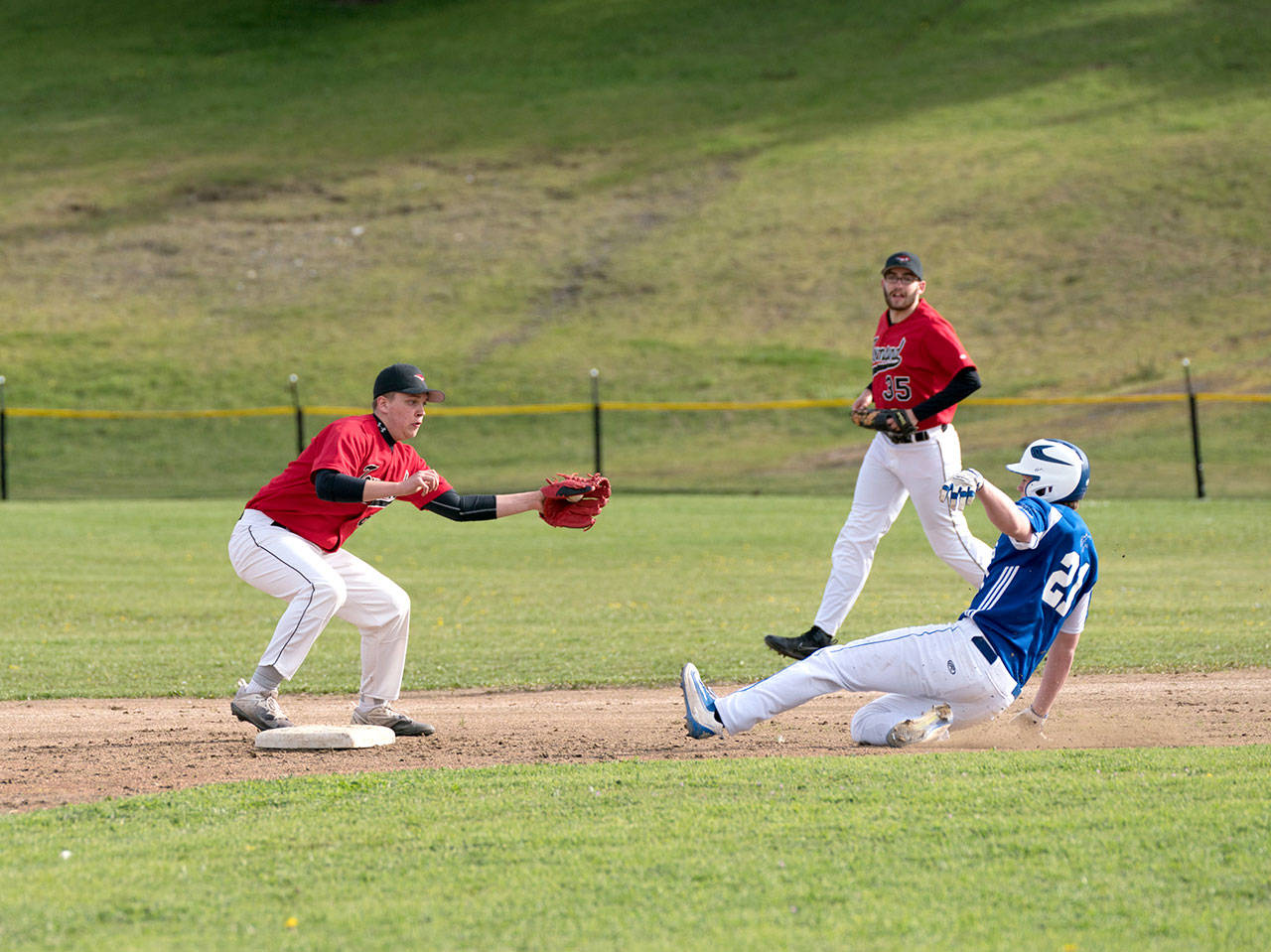 Port Townsend’s Payton Lake has the ball in glove but misses the tag at second on Chimacum’s Jonah Deihl in Monday afternoon baseball action in Port Townsend. Steve Mullensky/for Peninsula Daily News Steve Mullensky/for Peninsula Daily News Port Townsend’s Payton Lake has the ball in glove but misses the tag at second on Chimacum’s Jonah Deihl in Monday afternoon baseball action in Port Townsend.