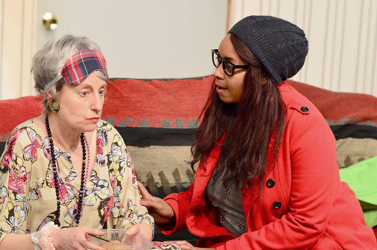 Gertrude (Michelle Hensel), left, reluctantly accepts help from Mandy (Jade Evans) in Key City Public Theatre’s “Wolf at the Door.” (Diane Urbani de la Paz/for Peninsula Daily News)