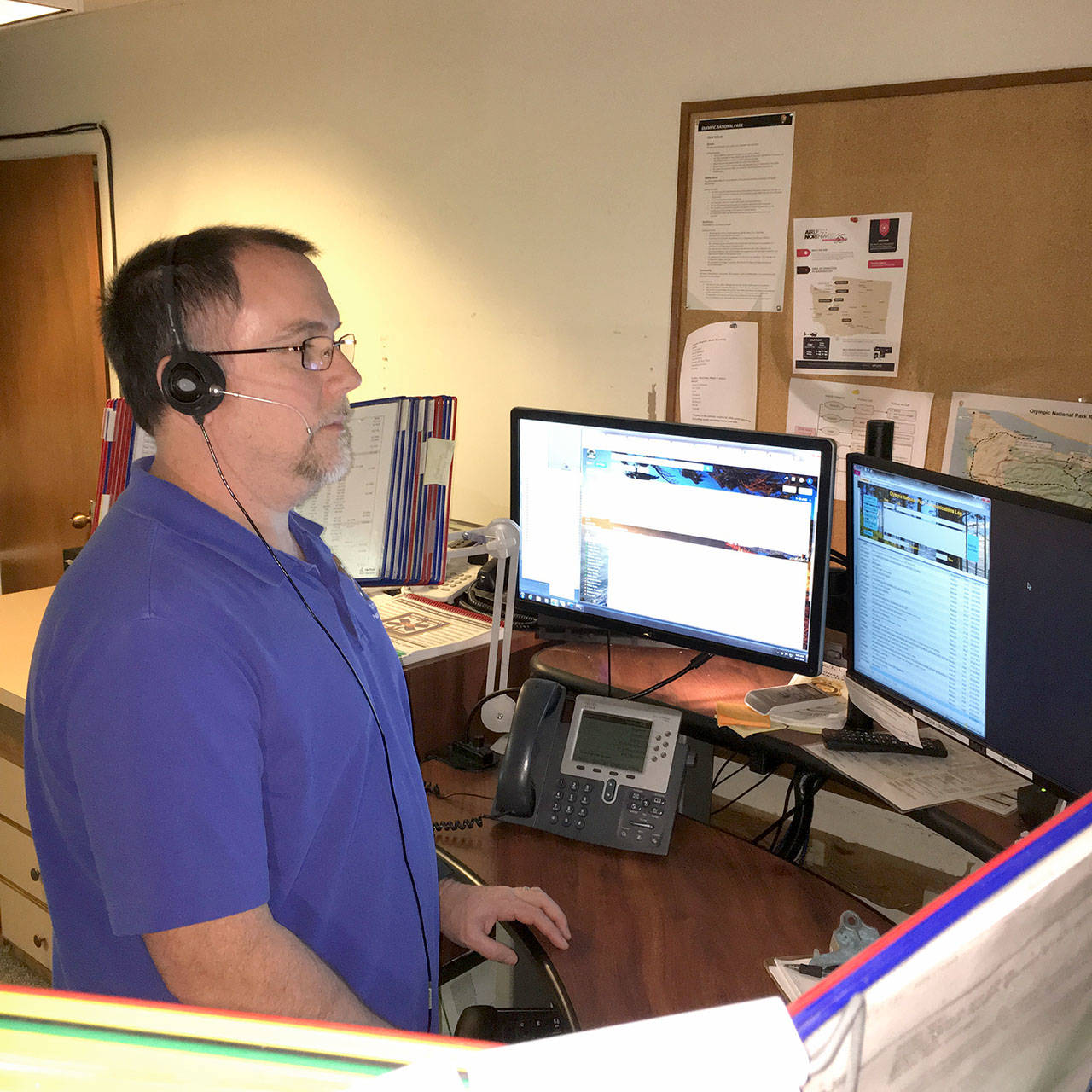 Kevin Watson, public safety dispatcher, takes calls at Olympic National Park on Tuesday. Thanks to a $1 million gift to Washington’s National Park Fund, Olympic National Park and Mount Rainier National Park are working together to implement a new computer aided dispatch system. (Penny Wagner/Olympic National Park)