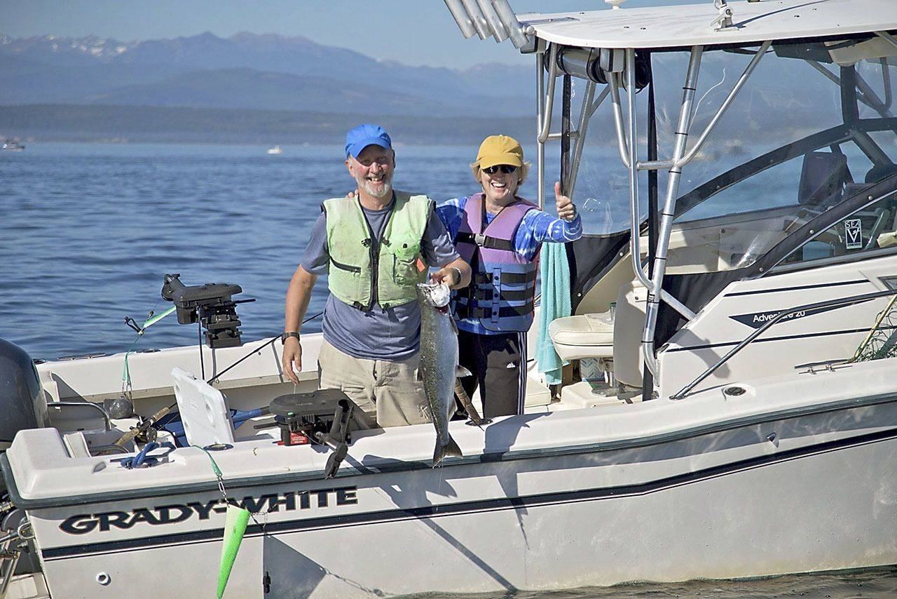 John Reed and Karen Overstreet, both of Seattle, show off a chinook caught while fishing at Midchannel Bank off Port Townsend in 2016. Steve Mullensky/for Peninsula Daily News
