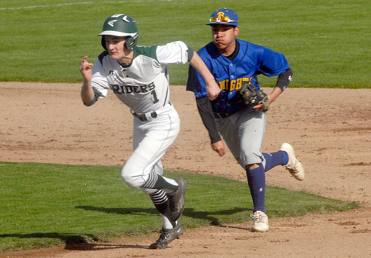 Port Angeles’ Daniel Basden tries to outrun Bremerton shortstop Hector Infante after being caught between bases during the first inning on Wednesday at Port Angeles Civic Field. Keith Thorpe/Peninsula Daily News