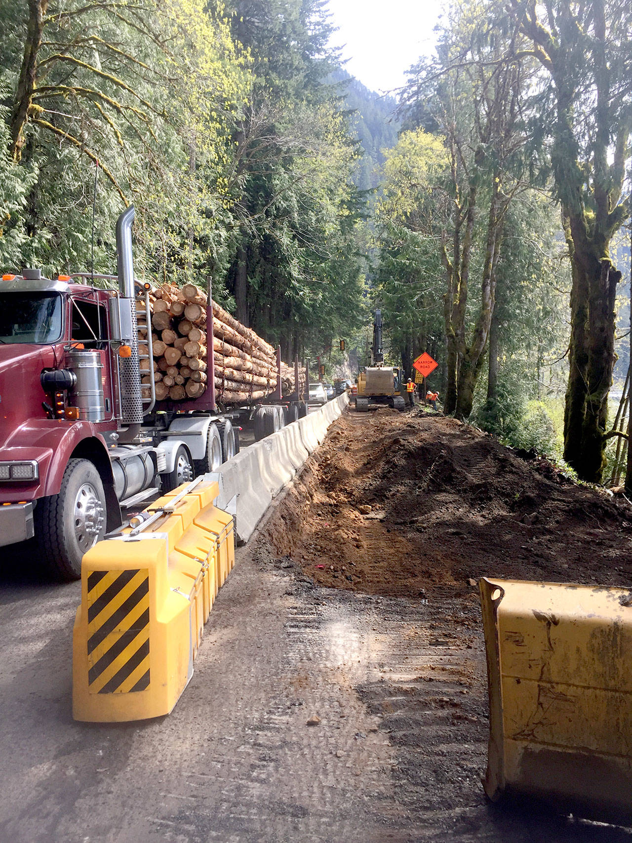 Traffic passes excavation work on U.S. Highway 101 at Lake Crescent. (Marty Flores)