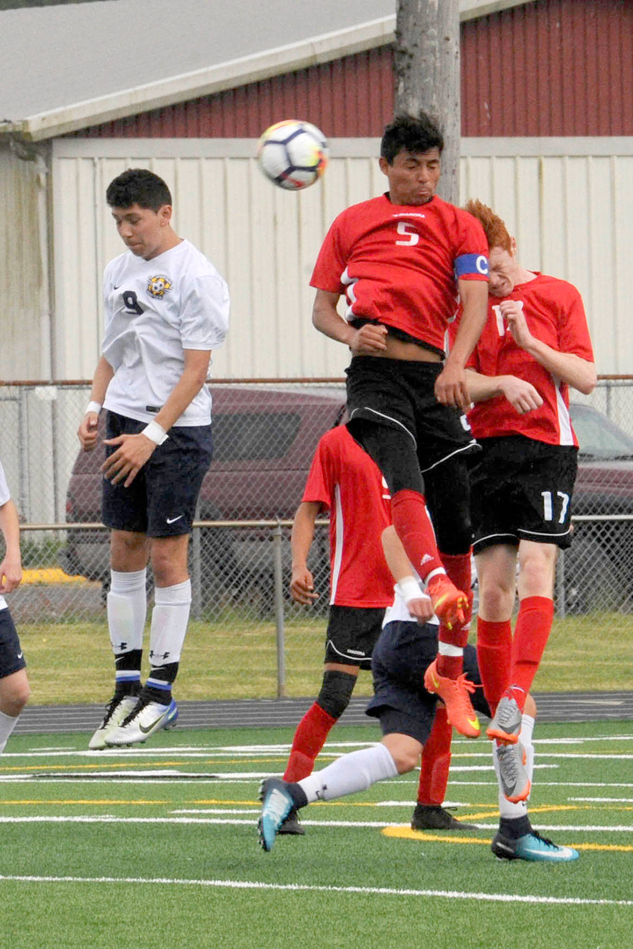 Lonnie Archibald/for Peninsula Daily News Forks’ Tony Flores, left, competes with Columbia (White Salmon) Fernando Aldana (5) and Liam Grim (17) for ball control during a Southwest District 4 playoff game at Spartan Stadium in Forks.