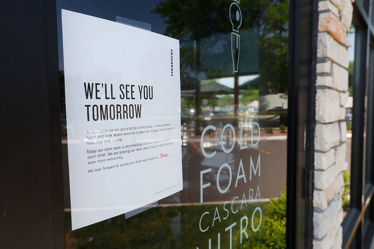 A sign announcing the store is closed is shown on the door of a Starbucks in Detroit on Tuesday. (Paul Sancya/The Associated Press)