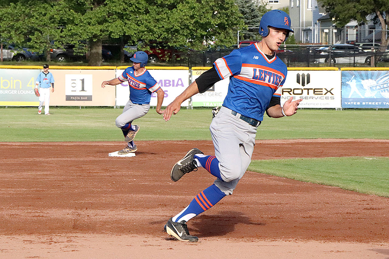 Port Angeles Lefties base runner Dalton Horum (front) heads for third base on his way to scoring, as teammate Matthew Christian rounds second, early in their road game against the Victoria HarbourCats on Wednesday. The Lefties came from behind to win the exhibition game 8-6.                                Don Descoteau/Black Press