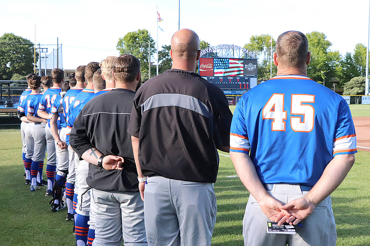 Don Descoteau/Black Press Port Angeles Lefties players and coaches line up during the national anthem before an exhibition road game against the Victoria HarbourCats at Royal Athletic Park on Wednesday.