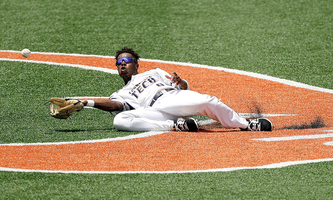 Tennessee Tech outfielder and former Port Angeles Leftie Alex Junior (9) makes a diving catch hit by Texas infielder David Hamilton in an NCAA super regional game Sunday in Austin, Texas. Junior roamed the outfield at Civic Field for the Lefties during the 2017 season. (The Associated Press)