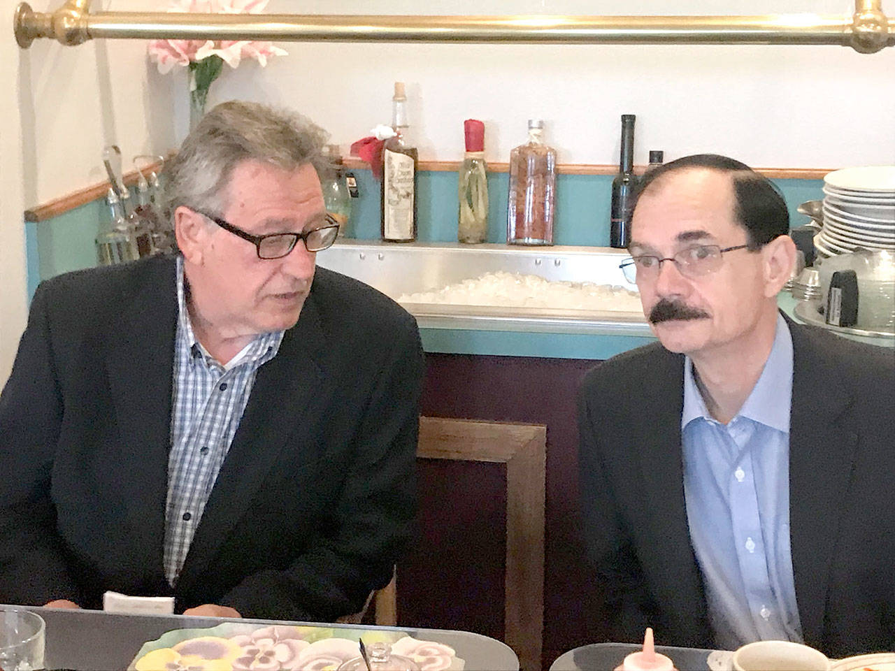 Clallam County commissioner candidates Dale Wilson, left, and Bill Peach chat before their primary election forum Tuesday. (Paul Gottlieb/Peninsula Daily News)