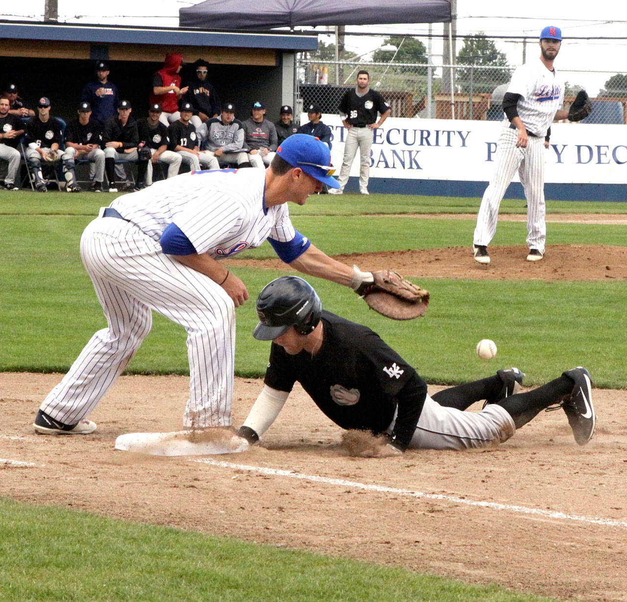 Dave Logan/for Peninsula Daily News Lefties first baseman Issac Wersland bobbles the ball as Cowlitz Black Bear Dalton Mitchell gets back to first base safely after a pick off throw from the PA pitcher Tim Reynolds Wednesday at Civic Field. Wersland hit a two-run home run in the game.
