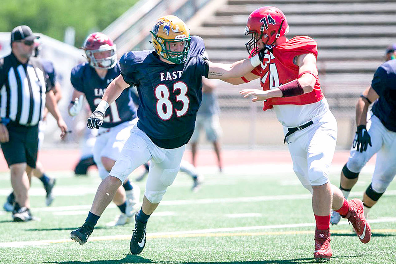 Yakima Herald                                Port Townsend’s Jackson Foster, right, blocks during the 24th annual East-West Earl Borden All-Star Football Classic last Saturday.