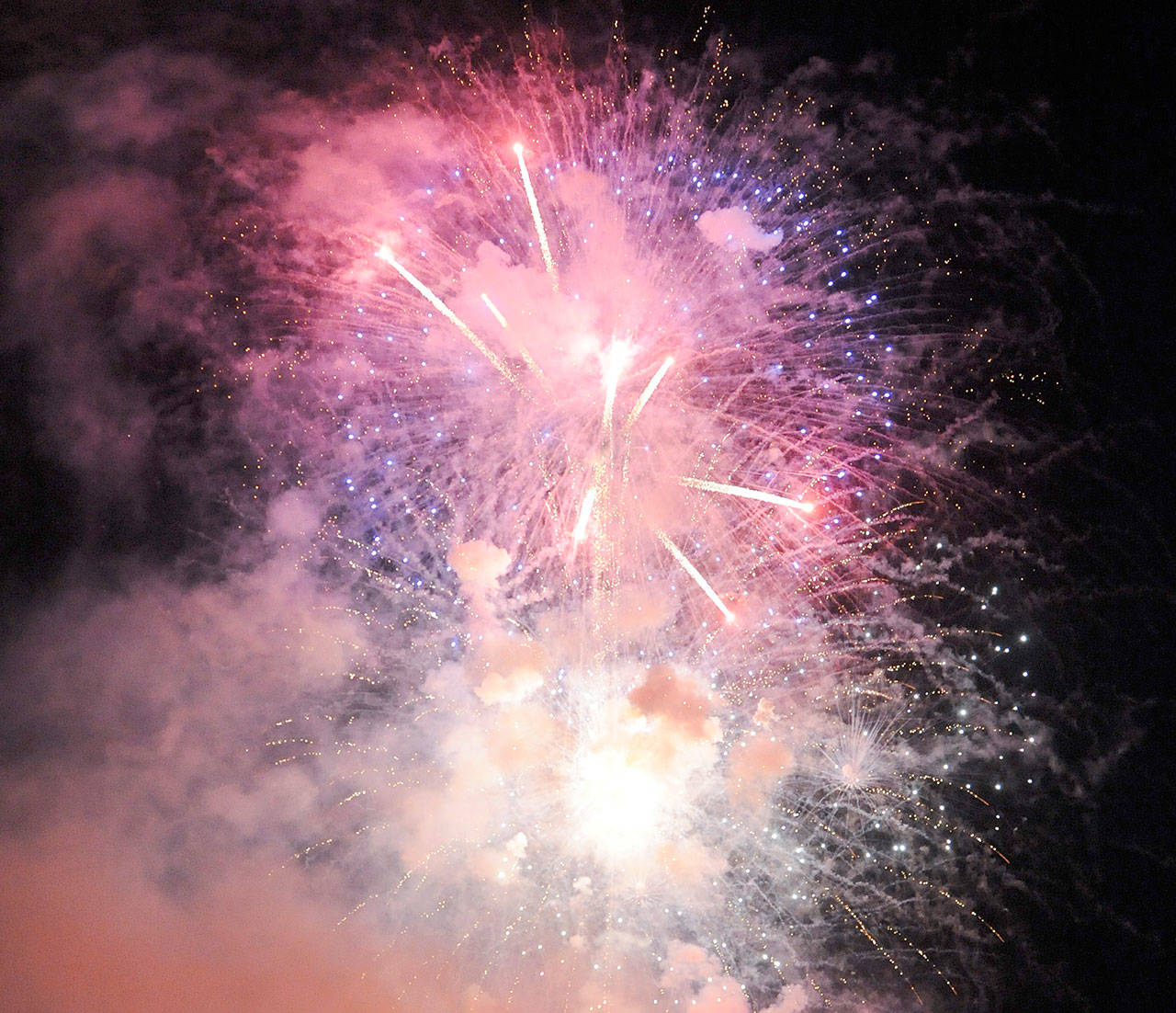 Festival-goers enjoy a fireworks display following the Sequim Irrigation Festival Logging Show in May. Under a new ordinance, fireworks public display are allowed in Sequim city limits but residents cannot discharge commercial fireworks. (Michael Dashiell /Olympic Peninsula News Group)