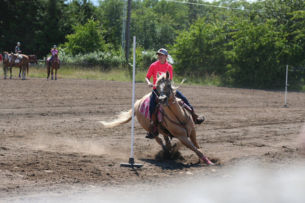Excitement was in the air at the Patterned Speed Horse Association game show held at Quarter Moon Ranch on Runion Road in Carlsborg in June. There, Brooke Stromberg, riding Sunny, ran her fastest pole racing time ever at 21.79 seconds. (Karen Griffiths/for Peninsula Daily News)