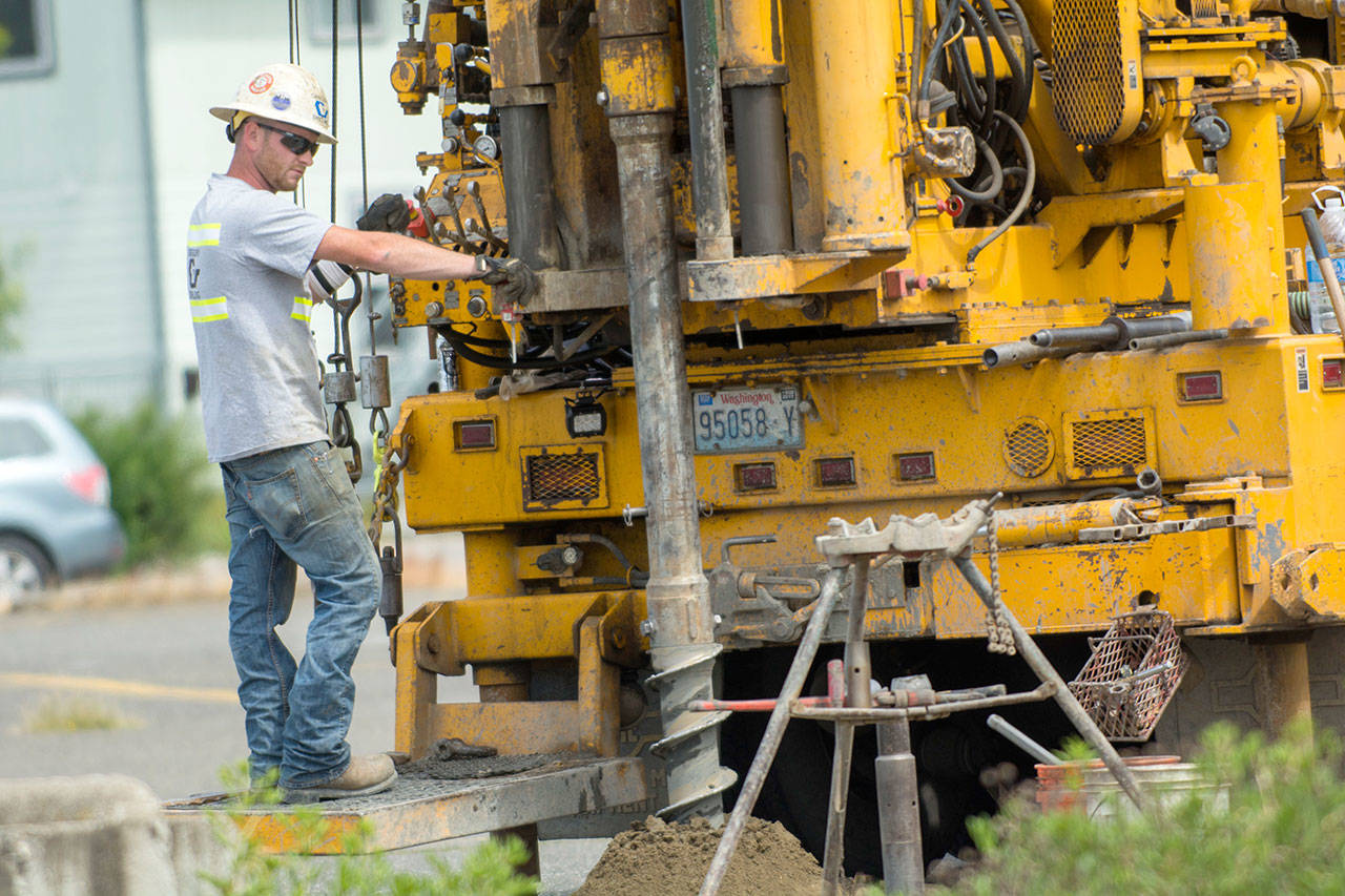 Crews take soil samples in a lot near Front and Oak streets for a proposed Port Angeles Waterfront Center. (Jesse Major/Peninsula Daily News)