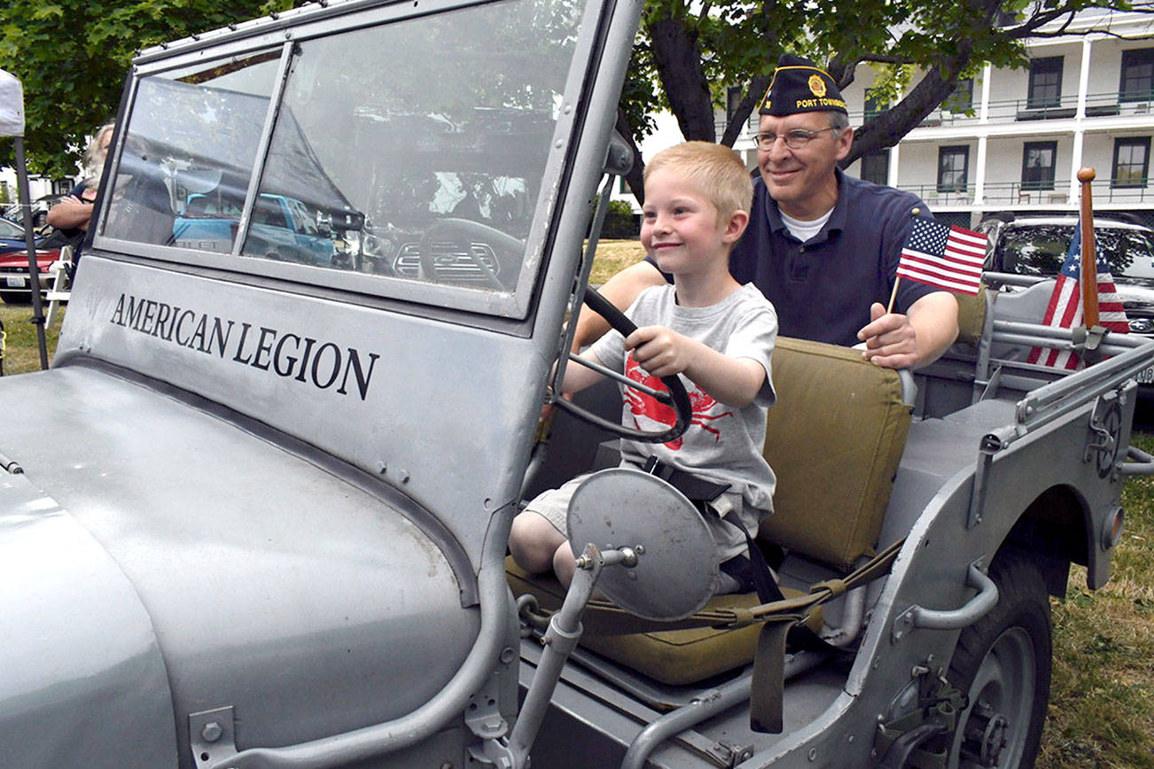 As part of Port Townsend’s Old School 4th of July festivities at Fort Worden, Marine Veteran Bob Saring of Port Townsend is with nephew Chance McFarland in a World War II Navy Jeep that was restored by a member of the local American Legion. (Jeannie McMacken/Peninsula Daily News)