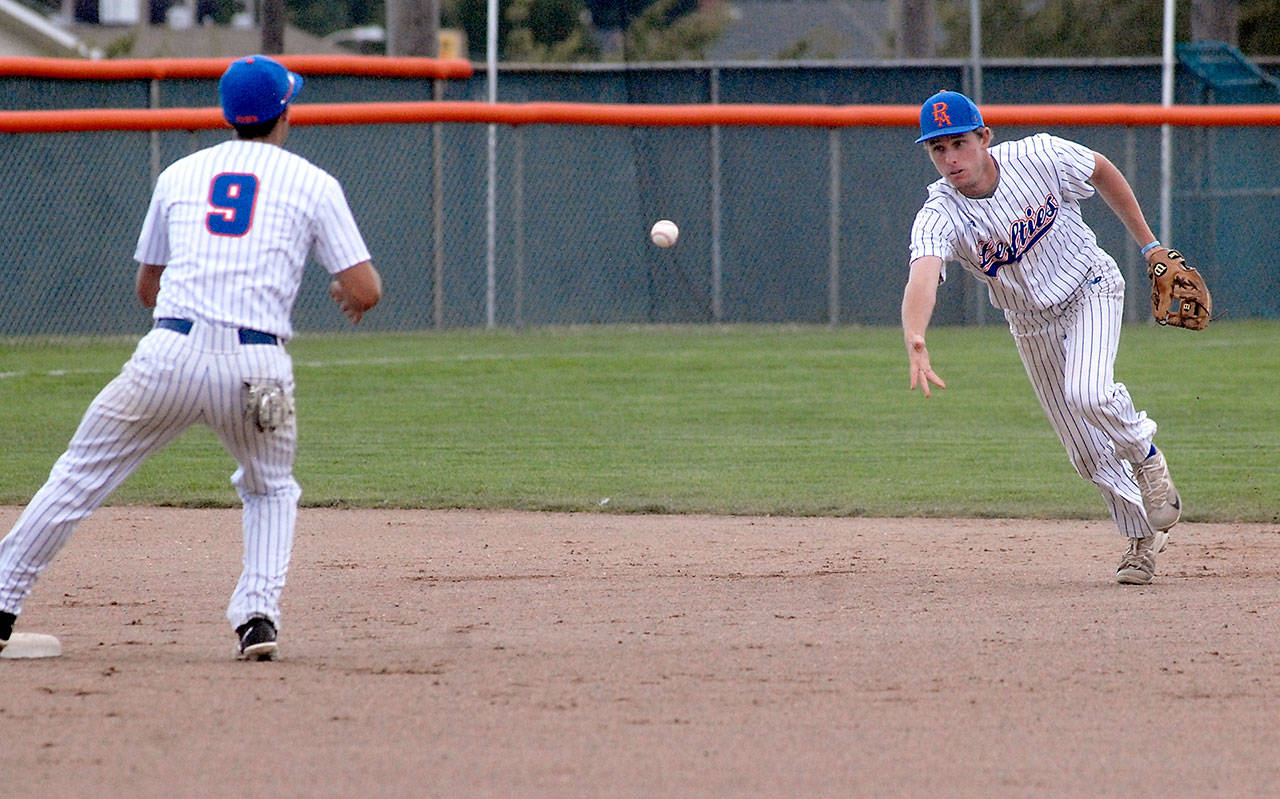 Lefties shortstop Trevor Rosenberg, right, tosses the ball to second baseman Jason Dicochea for a force out against the Yakima Pippins in the second inning on Friday evening at Port Angeles Civic Field. Dicochea hit a two-run home run in the bottom of the eighth inning that proved to be the difference in a 3-1 Lefties’ win. (Keith Thorpe/Peninsula Daily News)