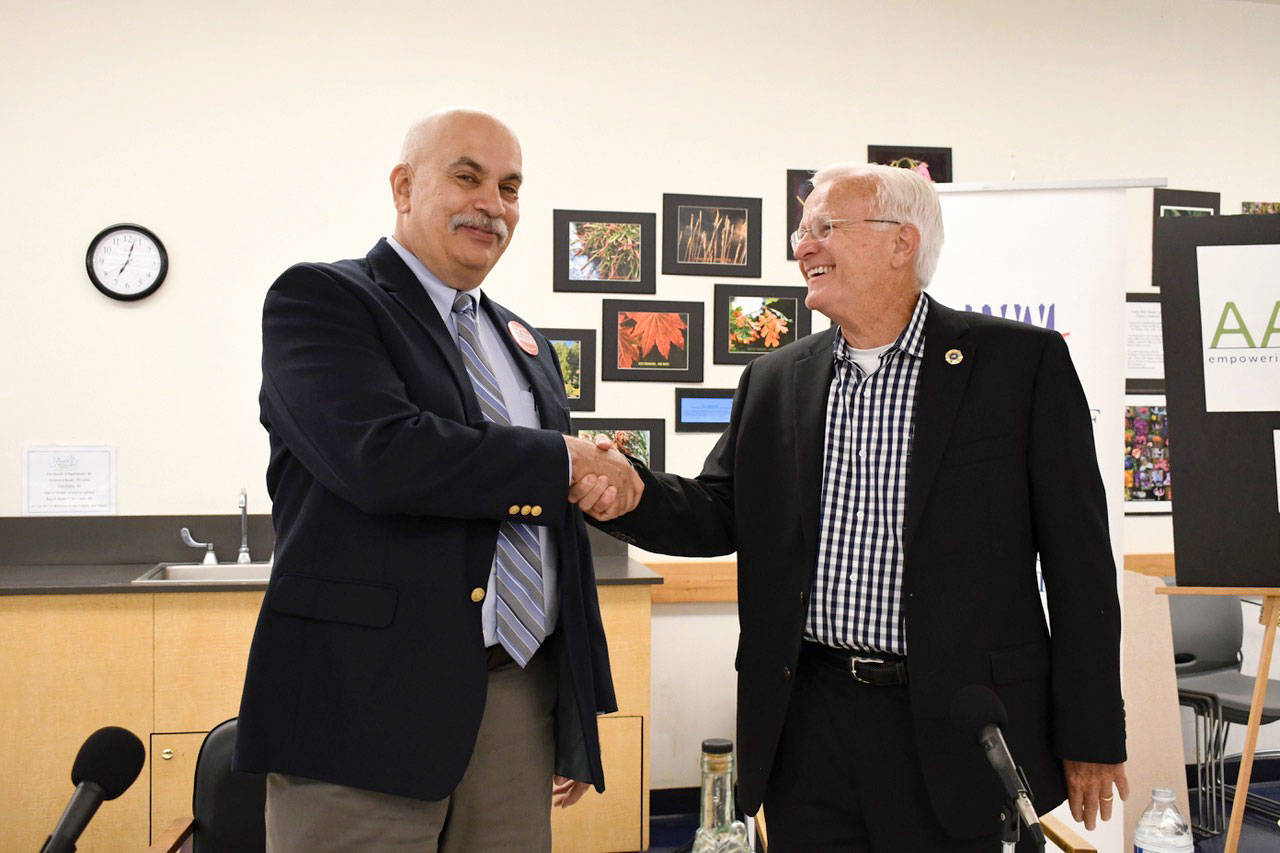 Joe Nole, left, and incumbent David Stanko meet at the candidate forum in Port Townsend to discuss their positions on issues relating to the job of Jefferson County sheriff. (Jeannie McMacken/ Peninsula Daily News)