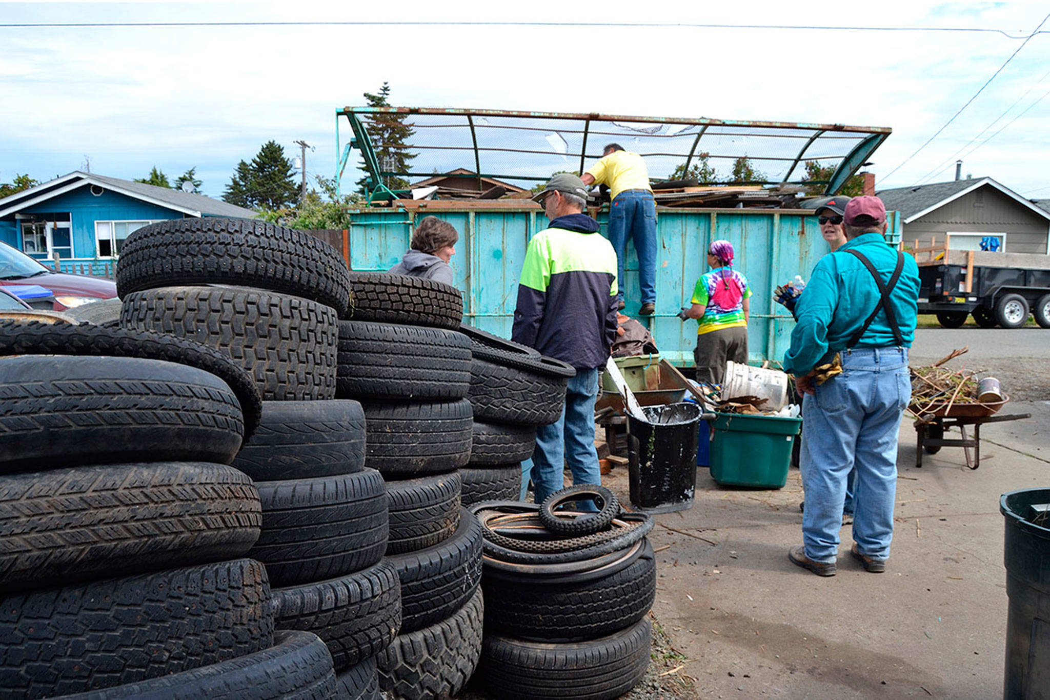 A new study on the city of Sequim’s code enforcement encourages working with volunteer groups such as Habitat for Humanity of Clallam County, members being pictured here during Sequim Service Fest in June, to help homeowners who want to comply with city standards but are unable to do so. (Matthew Nash/Olympic Peninsula News Group)