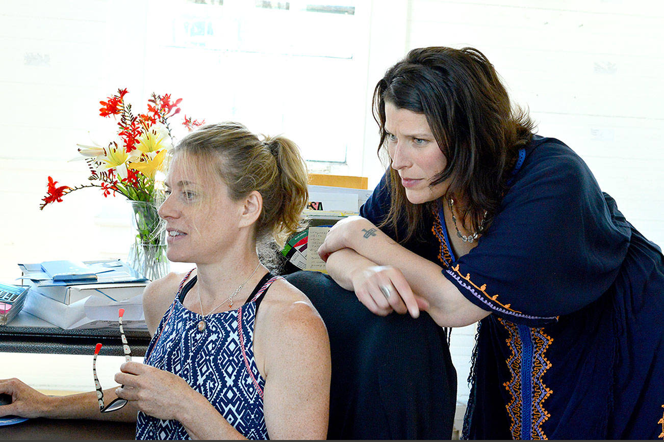 Staffers Julie Christine, seated, and Teresa Verraes coordinate classes and programs such as The Bunker at Fort Worden’s Port Townsend School of the Arts. photo by Diane Urbani de la Paz