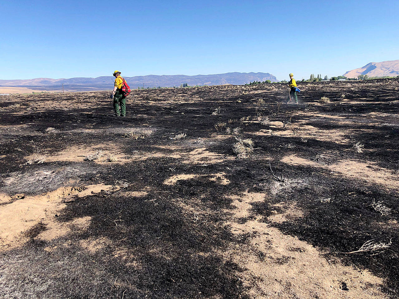 Quilcene firefighter Tyson Svetich and Port Ludlow firefighter Jacob Shepherd patrol for hot spots on the Buckshot Fire.