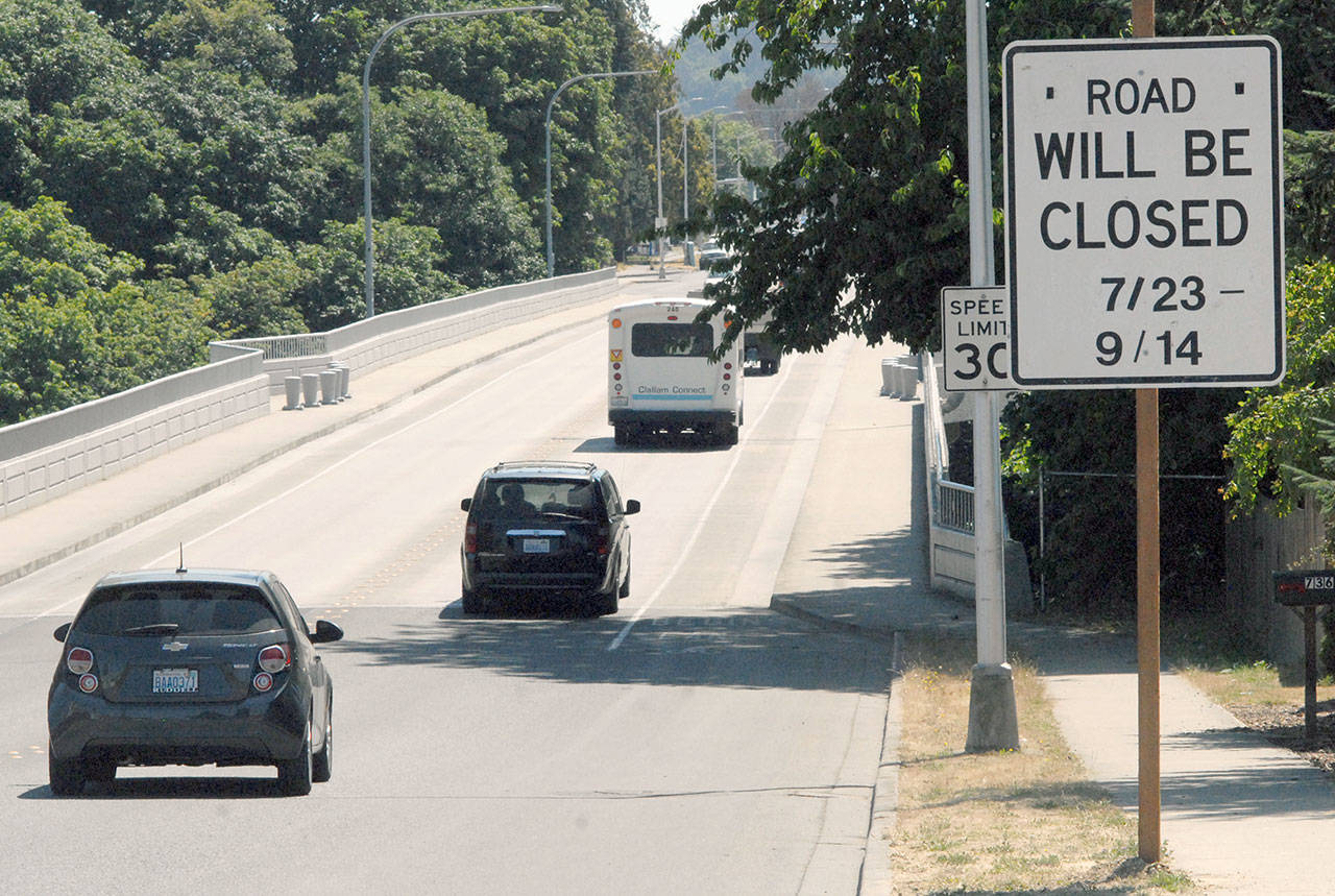 A sign on the west end of the Eighth Street bridge over Tumwater Creek in Port Angeles warns motorists of impending closures through September for replacement of the bridge railings. (Keith Thorpe/Peninsula Daily News)