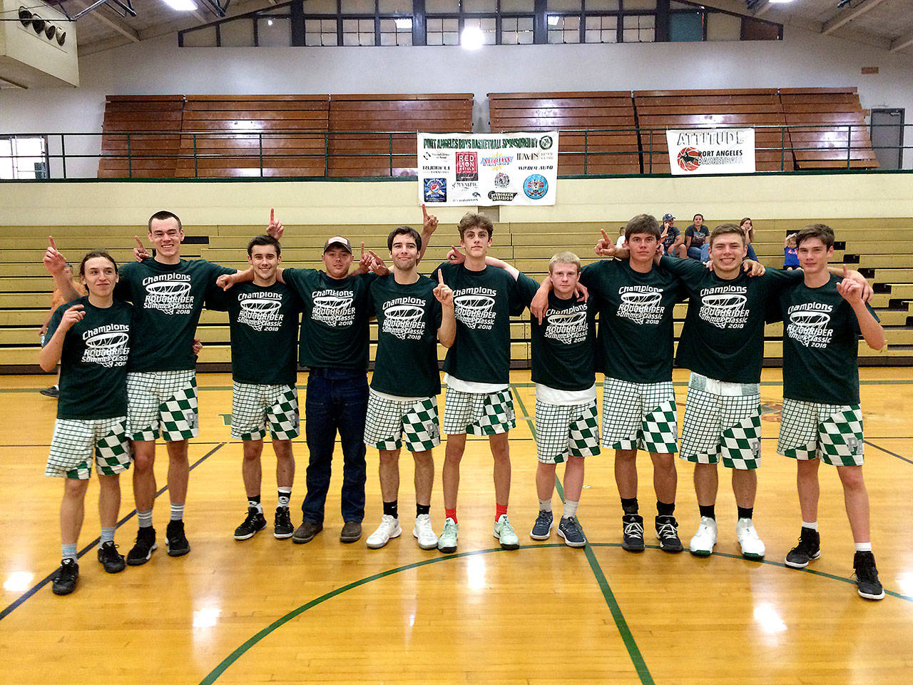The Port Angeles Roughriders varsity basketball squad celebrates Sunday winning the Roughriders Classic summer basketball tournaments,their second tournament win of the year. The Roughriders varsity went 31-9 during the summer season.