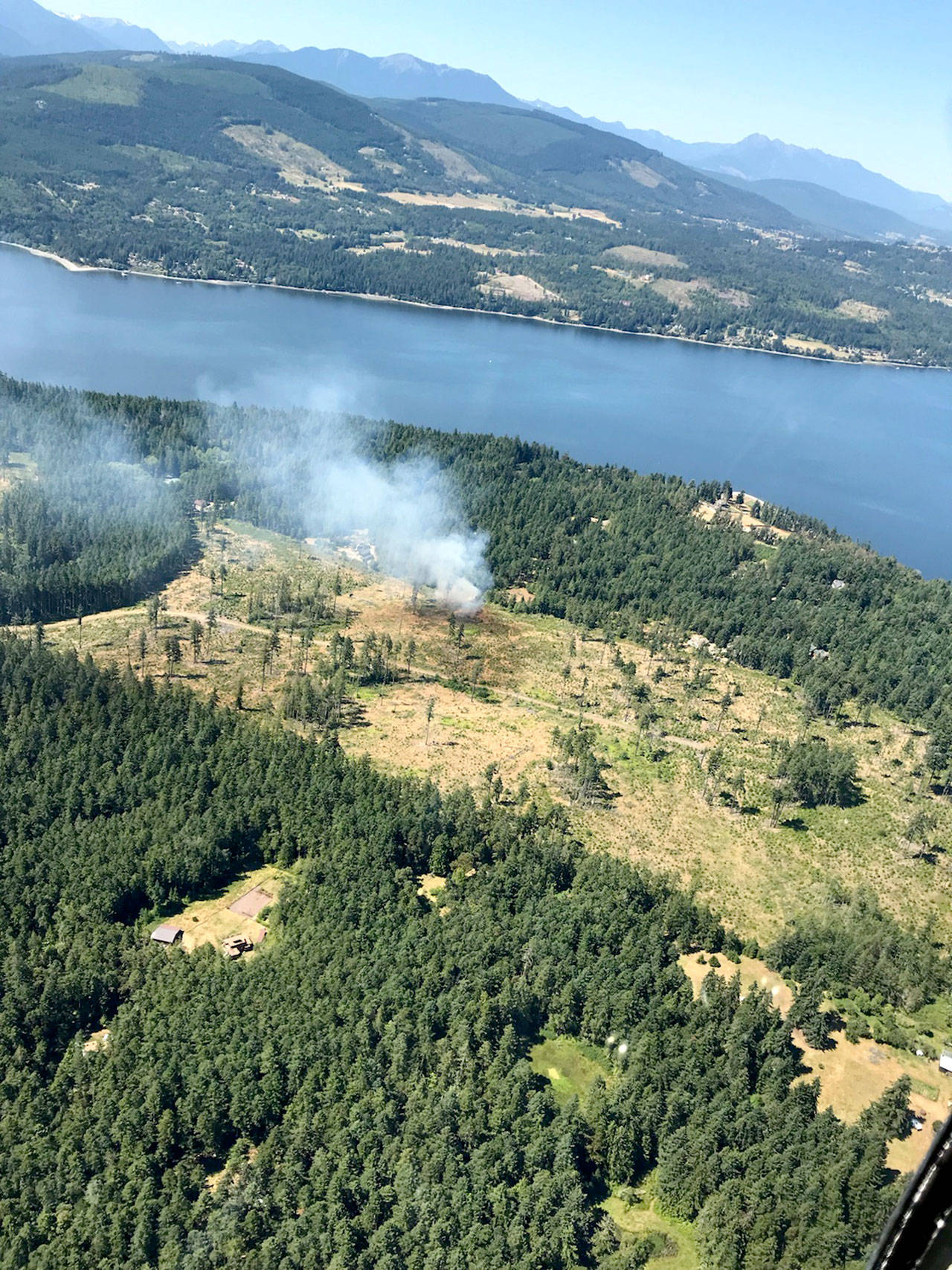 Clallam County Fire District No. 3 contained this brush fire near Sequim Bay to less than one acre Wednesday afternoon. The fire was in logging slash near Rhapsody Drive. (Mike Radford)