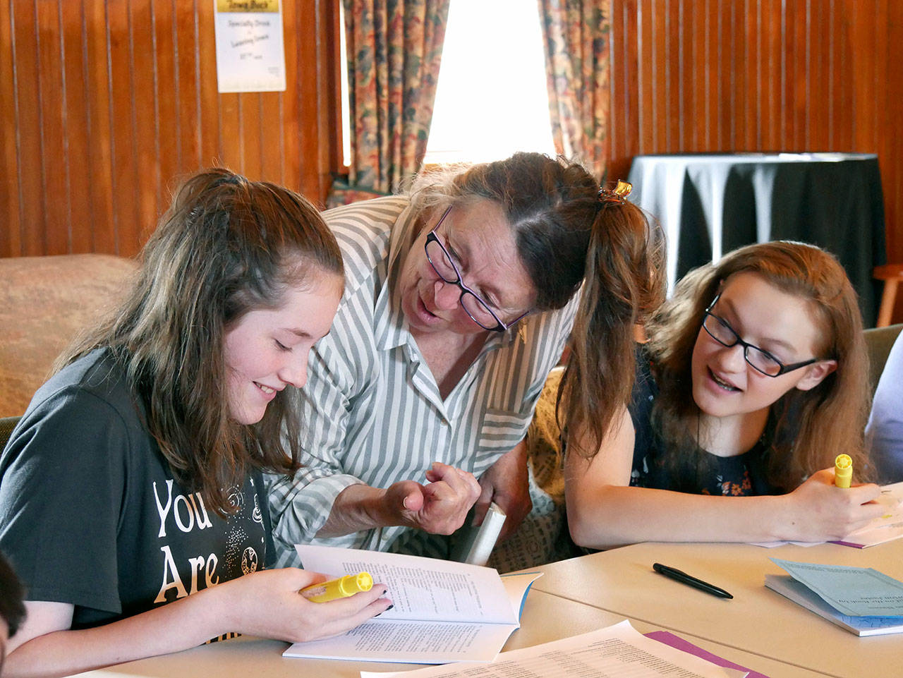 Ava Fuller, director Bonne Smith and Emily Loucks go over a script for “The Phantom Tollbooth.” (Pete Griffin)