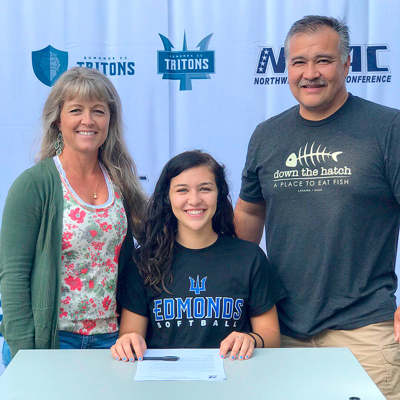 Edmonds Community College Athletics Sequim’s Jordan Bentz, center, has signed a letter of intent to play softball for the Edmonds Community College Tritons. The 2017 Sequim High School graduate is joined by her parents Melanie and Dave Bentz.