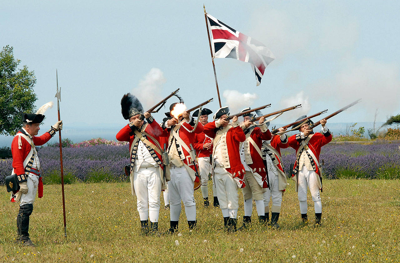 A group of Revolutionary War soldiers reenact the “Battle for Concord Bridge” during this weekend’s Northwest Colonial Festival at the George Washington Inn and Washington Lavender Farm at 939 Finn Hall Road near Agnew. The event featured other reenactments, historical discussions and demonstrations in a colonial village. (Keith Thorpe/Peninsula Daily News)
