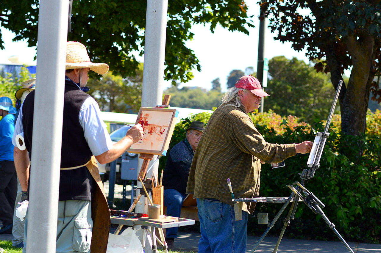 Robin Weiss of Poulsbo, left, and J. Brad Holt of Cedar City, Utah, have become good friends during the Paint the Peninsula competition and festival in Port Angeles. They’ve come back to partake in the weeklong event that includes the Paint Out from 1 p.m. to 4 p.m. this Friday, Aug. 24, along the Esplanade and City Pier. (Diane Urbani de la Paz/for Peninsula Daily News)