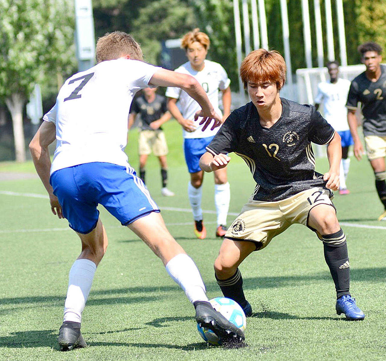 Jay Cline Peninsula’s Hide Inoue, right, defends against a Tacoma player during the Pirates season-opening match at Starfire Sports Complex in Tukwila on Thursday.