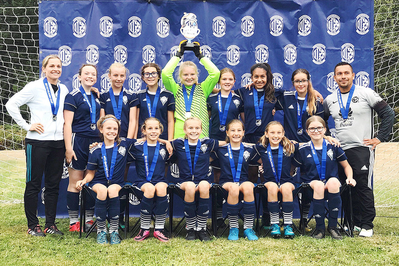 The Storm King Girls U13 team won the championship in the U13 division at the 2018 Island Cup soccer tournament held in Bainbridge Island from Friday through Sunday. Storm King went undefeated in its bracket, winning three games to qualify for the championship match where the girls beat the North Kitsap Reign 2-0. From left, back row, are assistant coach Robin Henrikson, Becca van Dyken, Ava-Anne Sheahan, Kaia Lestage, Paige Mason, Eve Breithaupt, Jennyfer Gomez, Julia Raupp and head coach Javier Gomez. From left, front row, are Ivy Barrett, Kinzley Henrikson, Jolene Vaara, Taryn Johnson, Gianna Riccobene and Charley Sturm. Not in the photo is Nikoline Updike.