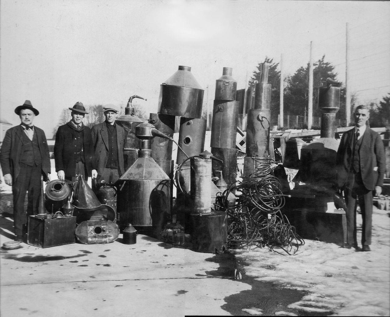 An illegal still was confiscated in 1923 during Prohibition. Shown here are, from left, Bob Banderob, Fred Rice, Mike Laslo and Sheriff John William “Jack” Pike. (John William Pike collection)