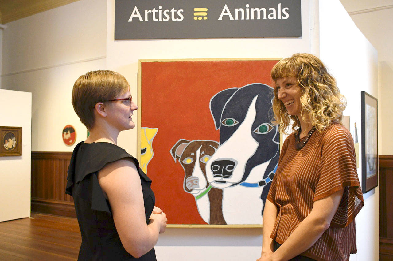 Jefferson County Historical Society Executive Director Shelly Leavens, right, discusses the new art exhibit at the Museum of Art & History with Ellie DiPietro, research center manager. The women are planning ways to connect history to the community through oral histories, internet access and an artist-in-residence program. (Jeannie McMacken/Peninsula Daily News)